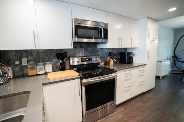 kitchen featuring backsplash, dark hardwood / wood-style flooring, stainless steel appliances, and white cabinets