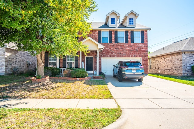 view of front of house featuring a garage and a front lawn