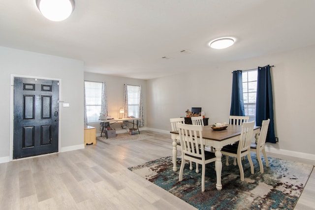 dining area featuring plenty of natural light and light wood-type flooring