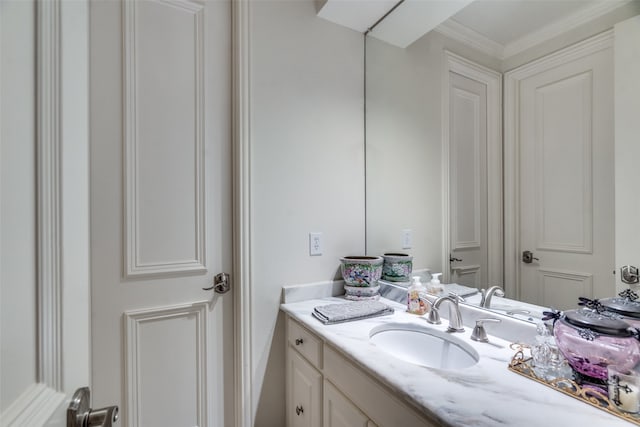 bathroom featuring crown molding and vanity