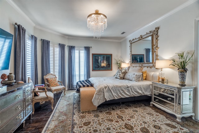 bedroom featuring wood-type flooring, ornamental molding, and an inviting chandelier