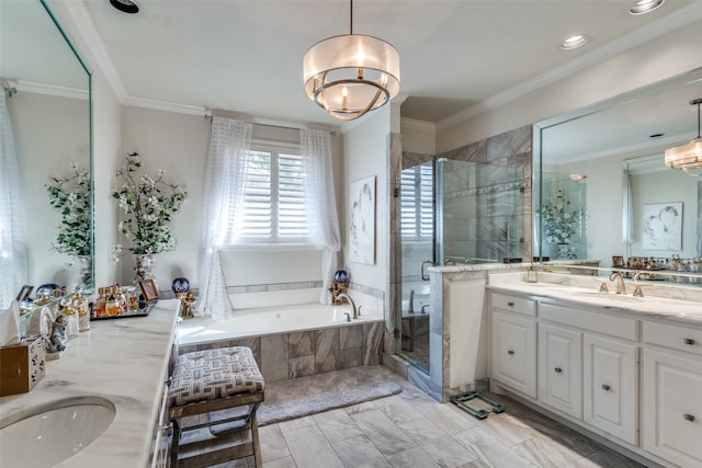 bathroom featuring crown molding, vanity, and separate shower and tub