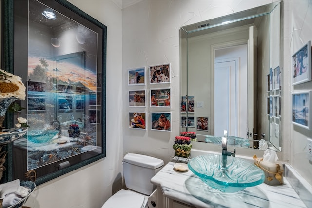 bathroom featuring vanity and toilet