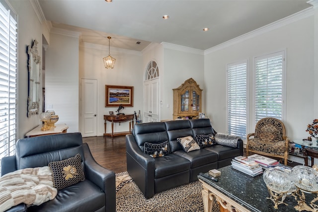 living room featuring an inviting chandelier, dark wood-type flooring, and crown molding