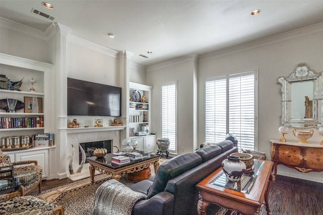 living room featuring a fireplace, dark hardwood / wood-style floors, and crown molding