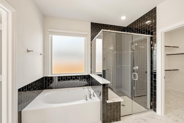 bathroom with separate shower and tub