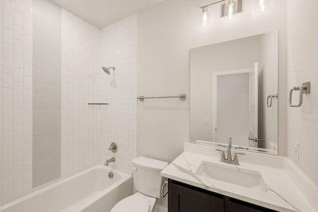 full bathroom with vanity, tiled shower / bath combo, and toilet