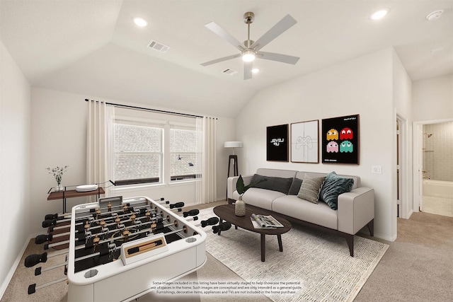 carpeted living room featuring ceiling fan and vaulted ceiling