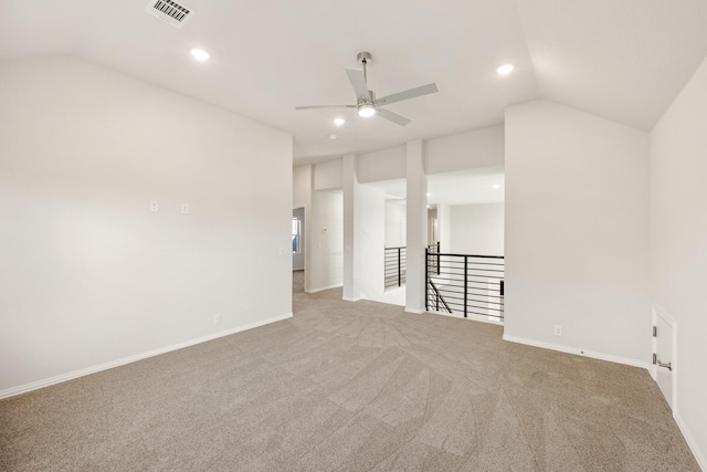 carpeted empty room with vaulted ceiling and ceiling fan