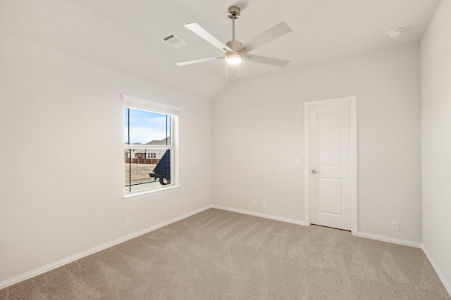 spare room with light carpet, lofted ceiling, and ceiling fan