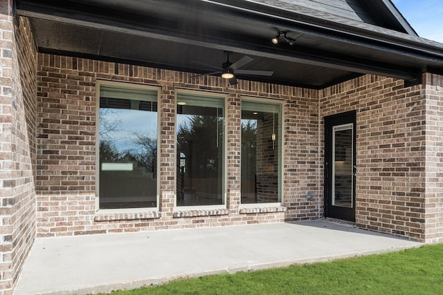 entrance to property featuring a patio area and ceiling fan