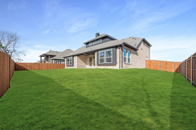 back of house featuring a yard