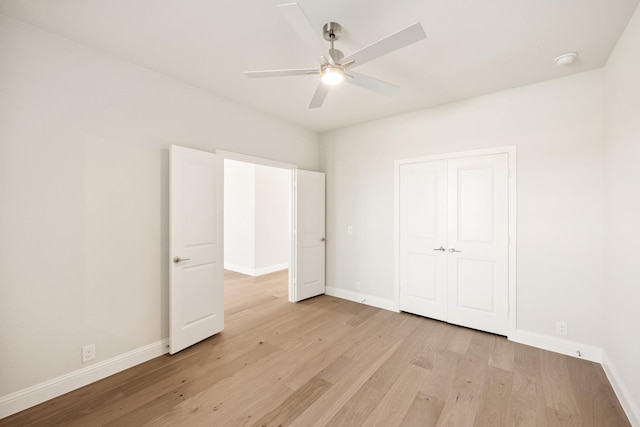 unfurnished bedroom featuring ceiling fan, a closet, and light hardwood / wood-style flooring