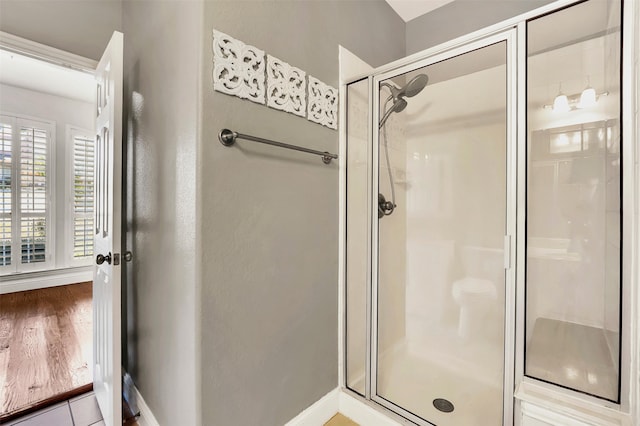 bathroom featuring wood-type flooring and walk in shower