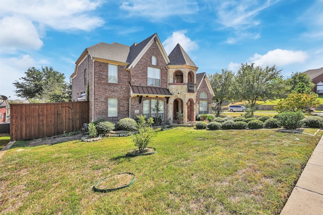 view of front of house with a front yard and central AC unit