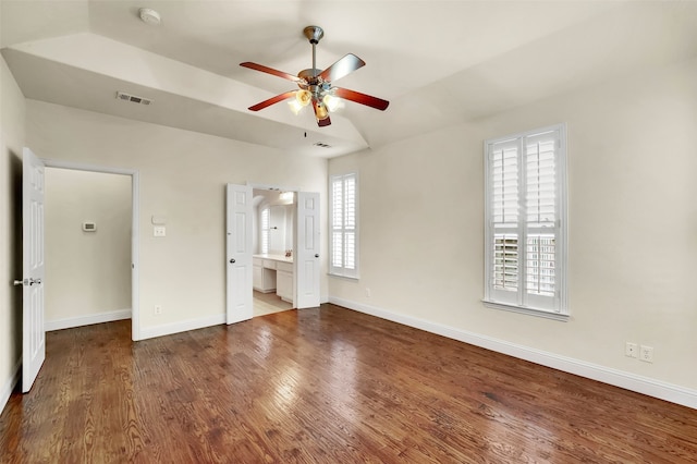 unfurnished bedroom featuring multiple windows, ceiling fan, and hardwood / wood-style flooring