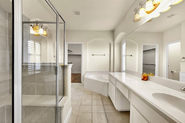 bathroom with vanity, separate shower and tub, tile patterned floors, and a healthy amount of sunlight