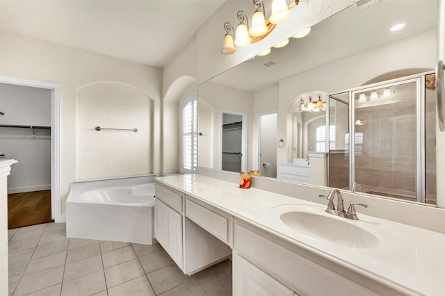 bathroom with plus walk in shower, tile patterned flooring, and vanity