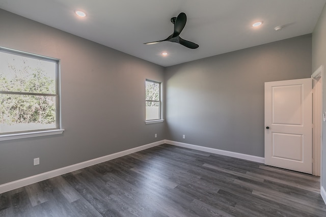 unfurnished room with dark hardwood / wood-style floors and ceiling fan