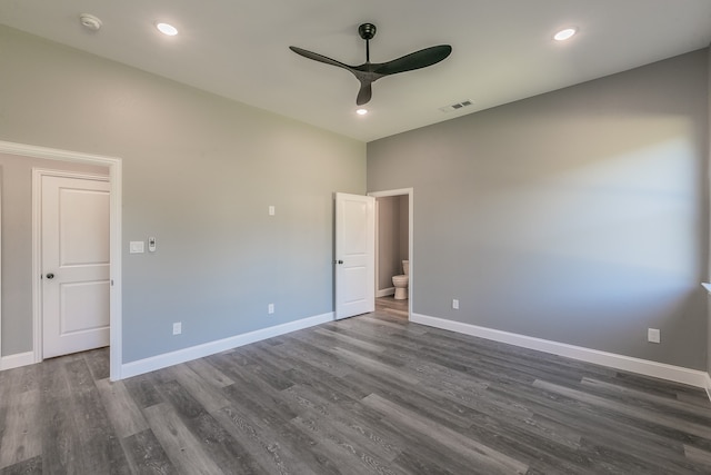 empty room with dark hardwood / wood-style flooring and ceiling fan