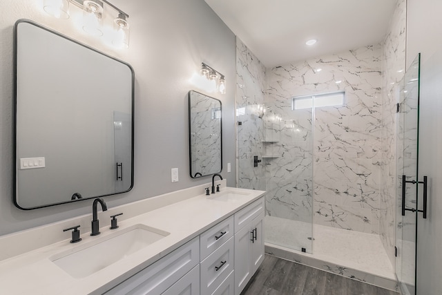 bathroom with vanity, wood-type flooring, and walk in shower