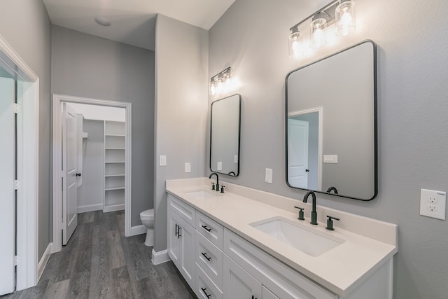 bathroom featuring hardwood / wood-style floors, vanity, and toilet