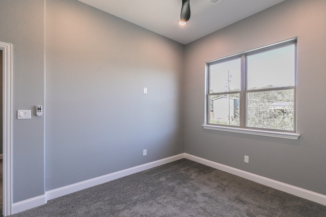 empty room featuring dark colored carpet