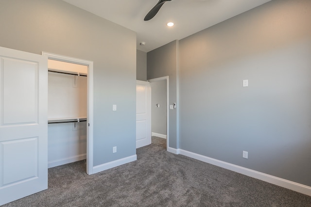 unfurnished bedroom with ceiling fan, a closet, and dark carpet