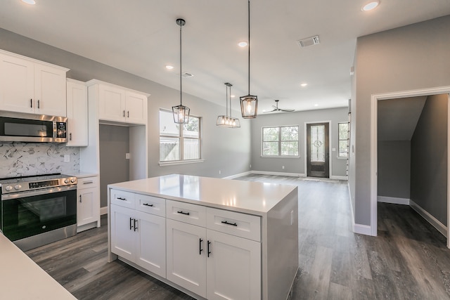 kitchen with white cabinetry, ceiling fan, stainless steel appliances, pendant lighting, and decorative backsplash