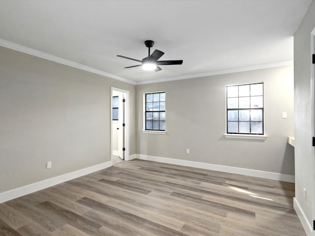 spare room featuring wood-type flooring, ornamental molding, and ceiling fan