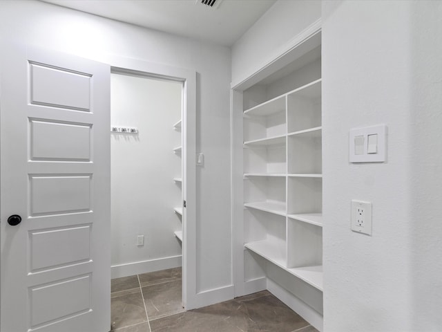 interior space with dark tile patterned floors