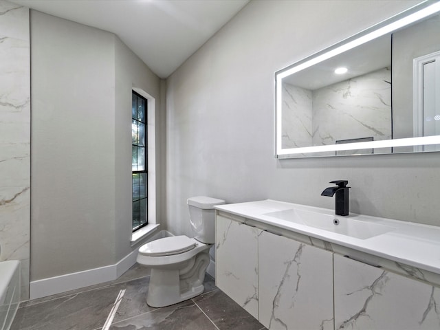 bathroom featuring vaulted ceiling, vanity, and toilet