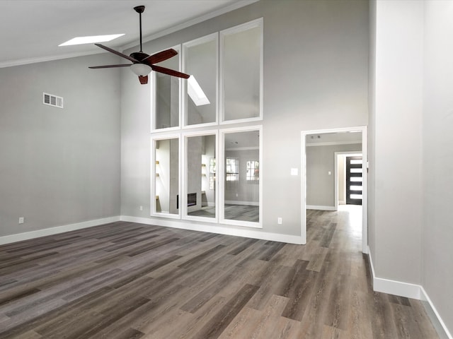 unfurnished living room with crown molding, dark hardwood / wood-style floors, and high vaulted ceiling