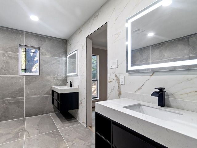 bathroom with vanity and tile walls