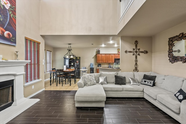 living room featuring dark hardwood / wood-style floors and a high ceiling