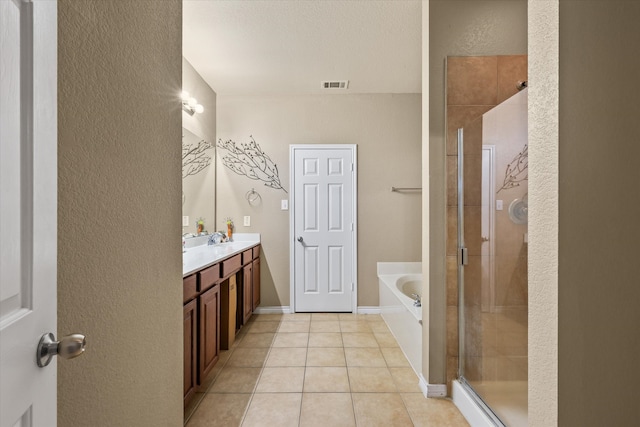 bathroom with shower with separate bathtub, vanity, and tile patterned floors