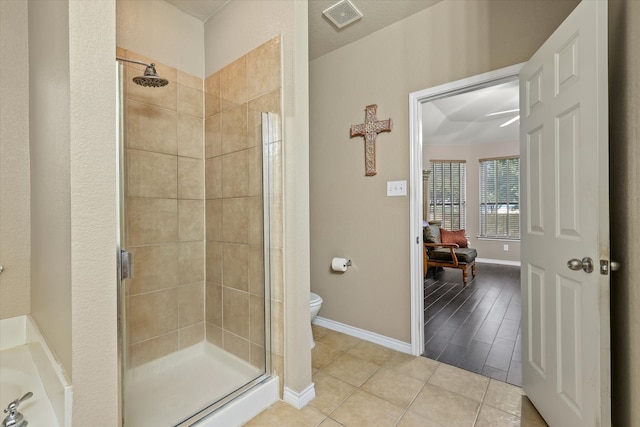 bathroom featuring walk in shower, hardwood / wood-style floors, and toilet