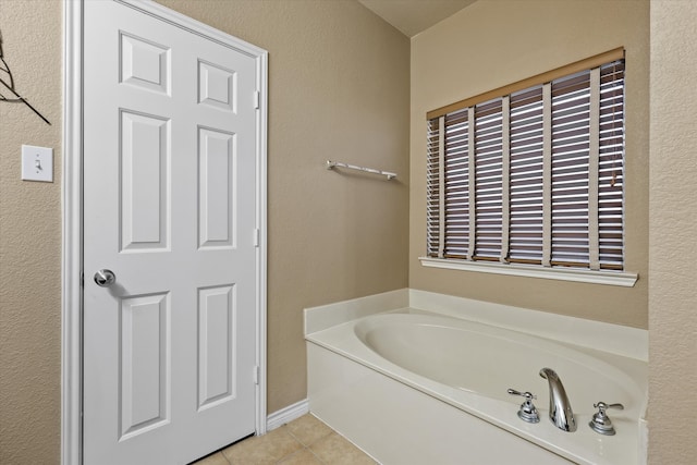 bathroom featuring tile patterned floors and a tub