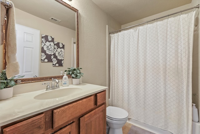 bathroom with a shower with shower curtain, a textured ceiling, vanity, and toilet