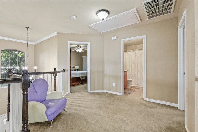 living area featuring crown molding and light colored carpet