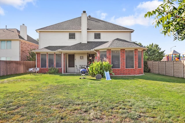 back of house with a lawn