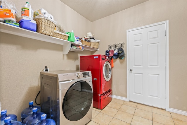 laundry room featuring light tile patterned flooring and washer and clothes dryer