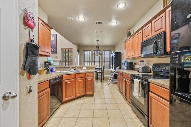 kitchen with hanging light fixtures, light tile patterned floors, a textured ceiling, black appliances, and sink