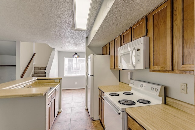 kitchen featuring white appliances and a textured ceiling