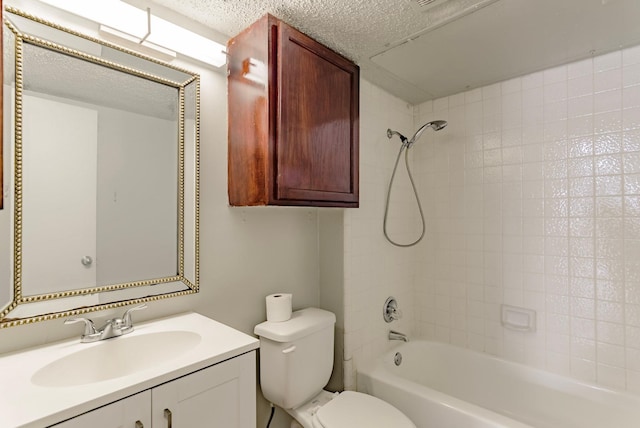 full bathroom featuring tiled shower / bath, vanity, toilet, and a textured ceiling