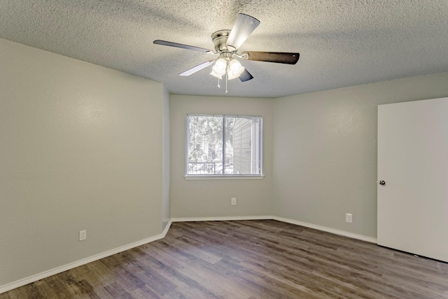 empty room with ceiling fan, hardwood / wood-style flooring, and a textured ceiling