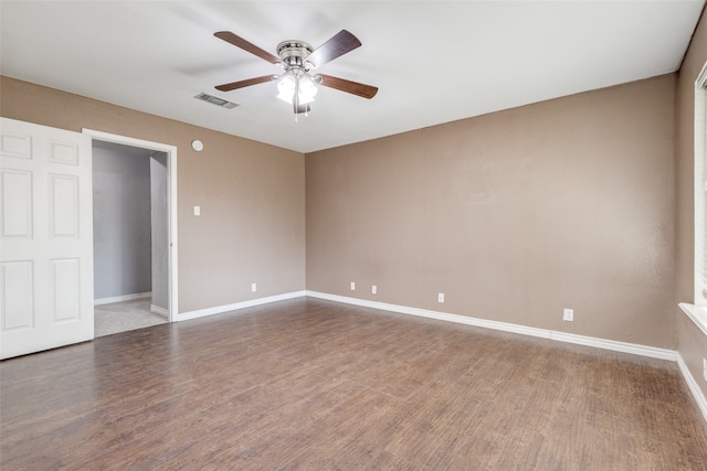 unfurnished bedroom featuring ceiling fan and dark wood-type flooring