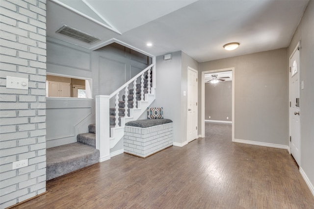 foyer entrance featuring wood-type flooring and ceiling fan