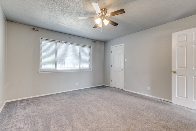 spare room with light carpet, a textured ceiling, and ceiling fan