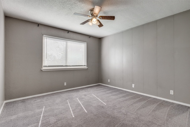 unfurnished room featuring ceiling fan, light carpet, and a textured ceiling